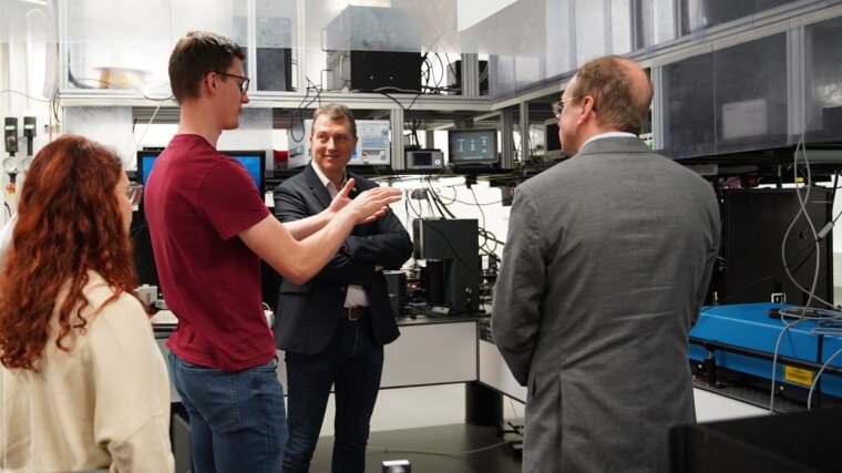 Maximilian Weißflog explains a set-up to Australian guests during a lab tour