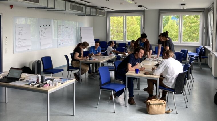 Doctoral candidates work in groups during a PhD workshop